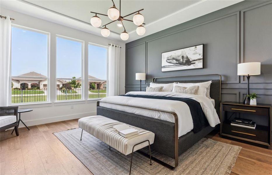 Expansive owner's suite with impressive windows and elegant tray ceiling  *Real home pictured