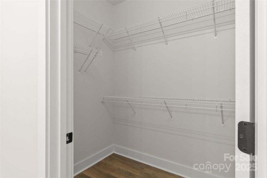 Primary bedroom walk in closet