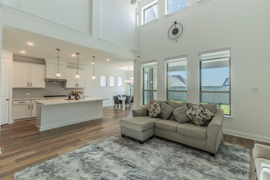 Open-concept living area with soaring ceilings and abundant natural light