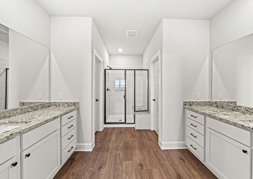 Master bathroom with two vanities and a step-in shower