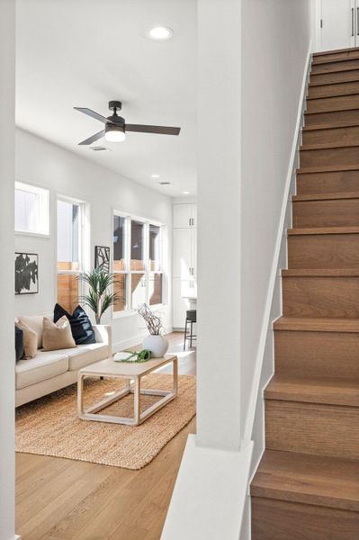 Living area featuring recessed lighting, stairs, wood finished floors, and a ceiling fan Living area featuring recessed lighting, stairs, wood finished floors, and a ceiling fan