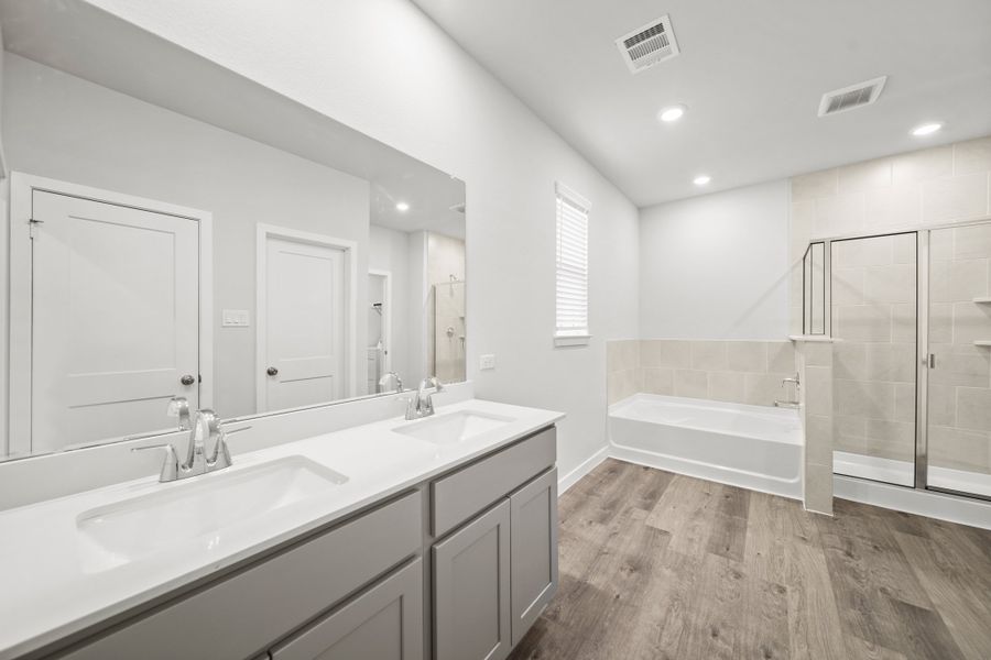 A bathroom with a tub sink and a shower.