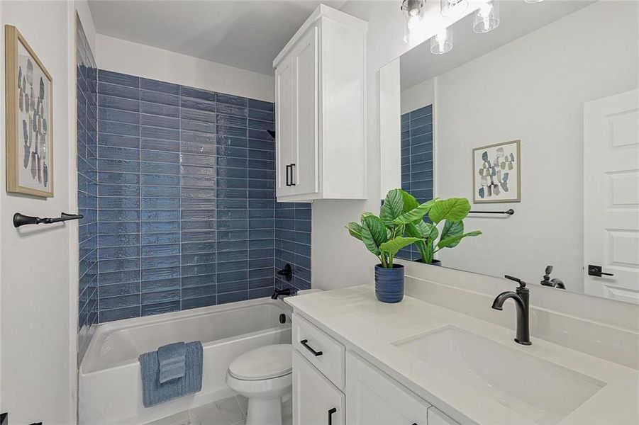 Full bathroom with tub/shower combo, linen storage and decorative lighting