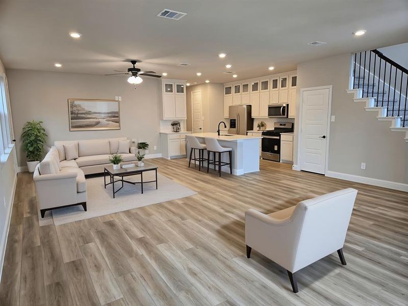 Living area with recessed lighting, ceiling fan, and light wood-style floors Living area with recessed lighting, ceiling fan, and light wood-style floors