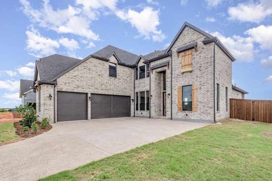 Front exterior of a new home in Malabar Hill, Prosper, TX, highlighting curb appeal (Image 2). Front exterior of a new home in Malabar Hill, Prosper, TX, highlighting curb appeal (Image 2).