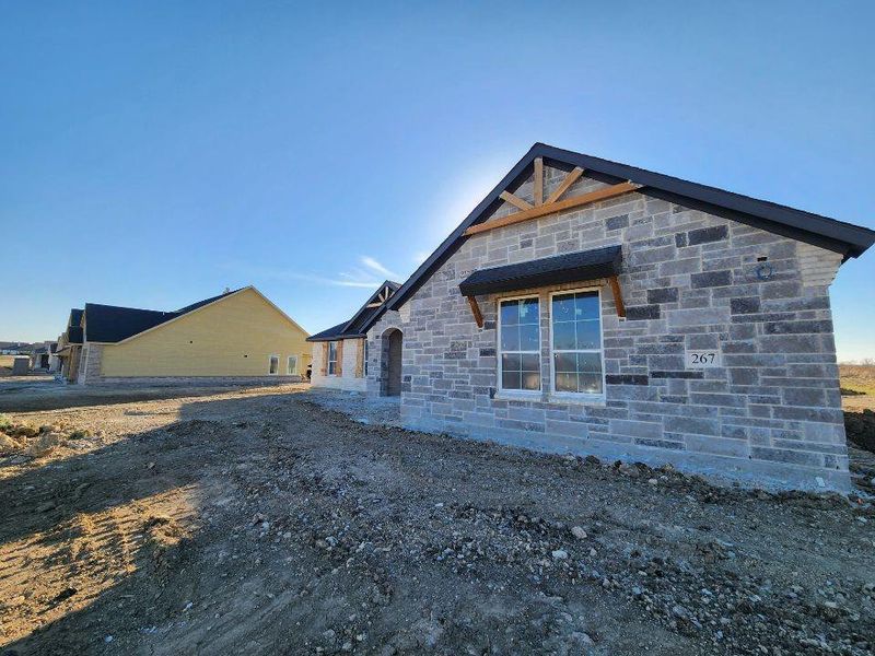View of property exterior with stone siding