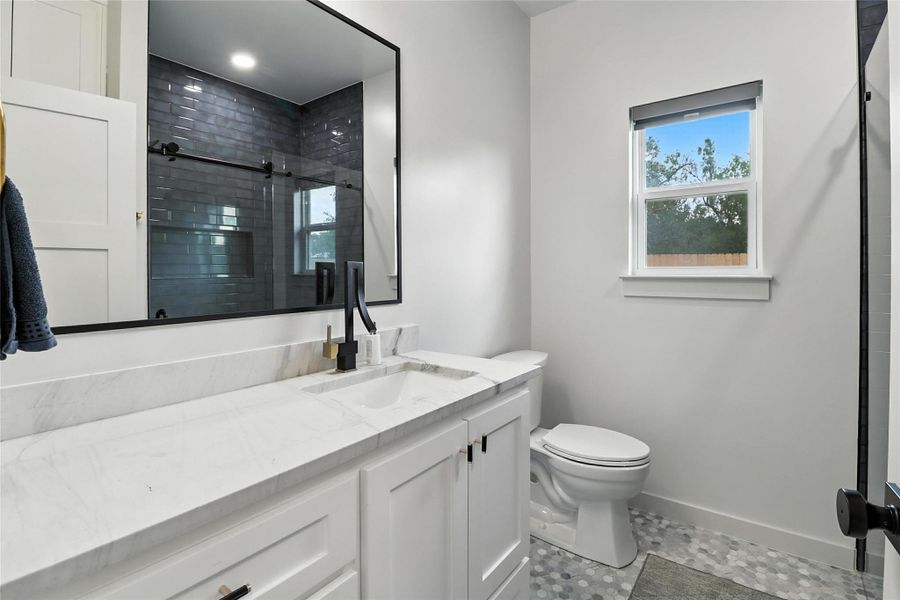 Bathroom featuring vanity, a shower stall, and light tile patterned floors