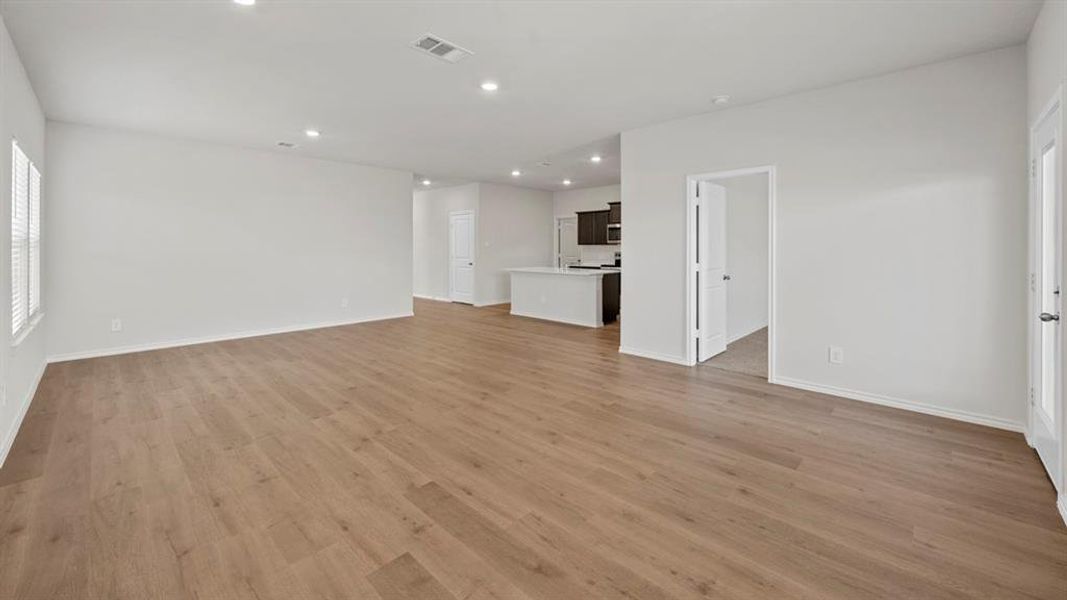 Unfurnished living room with light wood-style flooring and recessed lighting