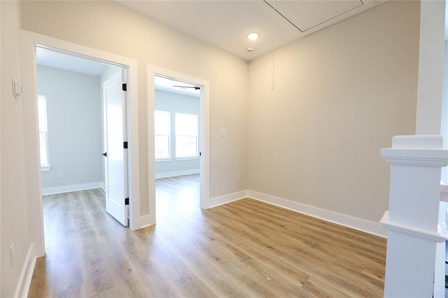 Upstairs features a hallway nook that could be used as a decorate space or home office area.