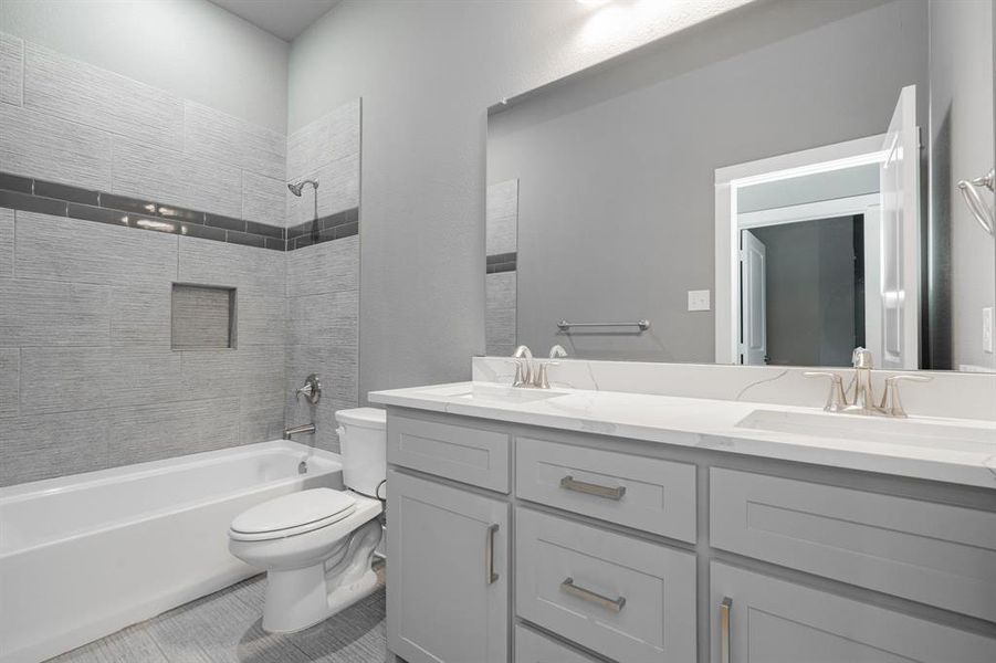 Bathroom with a sink, shower / bathing tub combination, toilet, and double vanity Bathroom with a sink, shower / bathing tub combination, toilet, and double vanity
