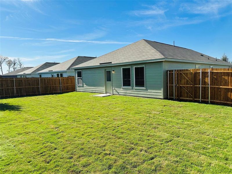 Rear view of house featuring a yard