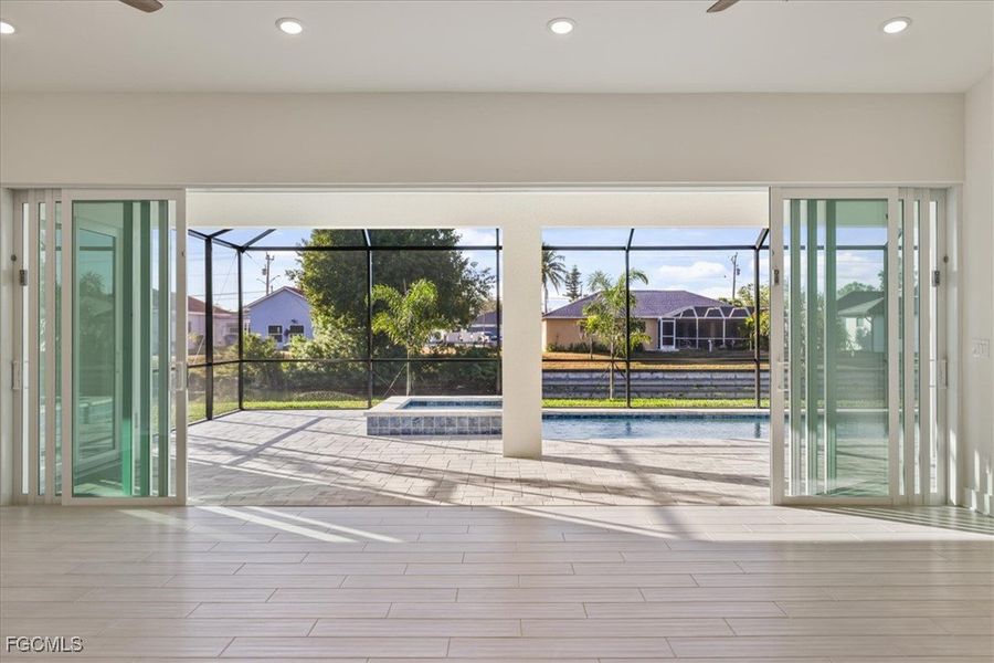 Doorway with a ceiling fan, recessed lighting, plenty of natural light, and a sunroom