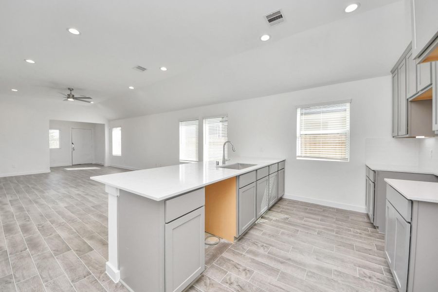 The open concept effortlessly connects the kitchen to the expansive family room, forming a perfect hub for gatherings. This seamless flow creates an inviting space where cooking and socializing come together harmoniously.