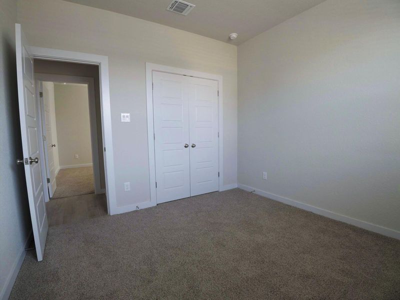 Unfurnished bedroom with carpet and a closet Unfurnished bedroom with carpet and a closet