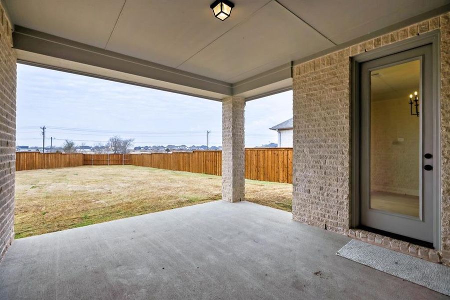 Fenced backyard with a patio