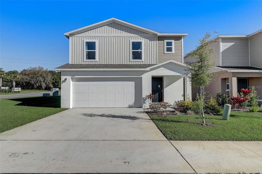 Front exterior of a new home in Bradbury Creek, Haines City, FL, highlighting curb appeal (Image 22). Front exterior of a new home in Bradbury Creek, Haines City, FL, highlighting curb appeal (Image 22).