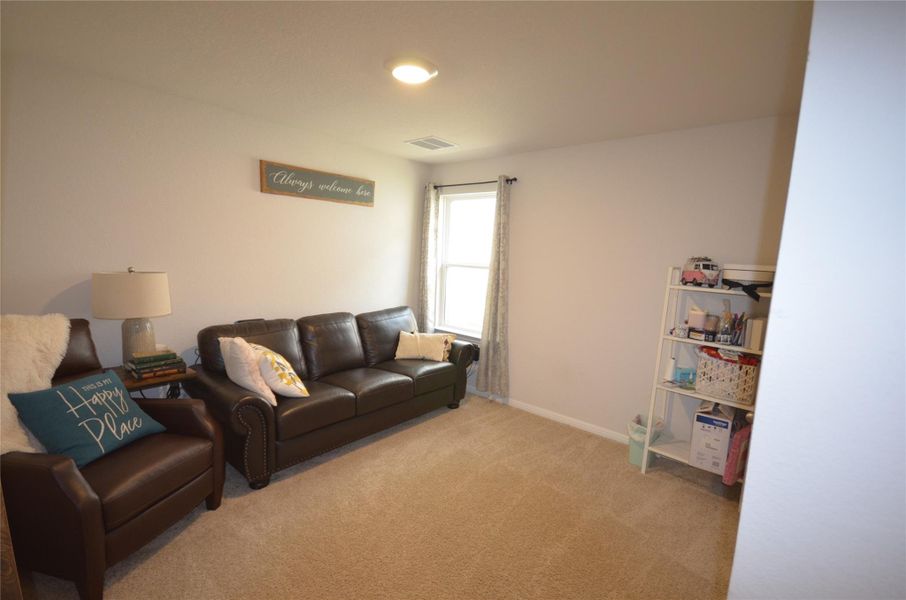 Living room with carpet floors and baseboards Living room with carpet floors and baseboards