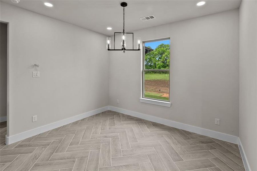 Unfurnished room featuring baseboards, recessed lighting, and a chandelier