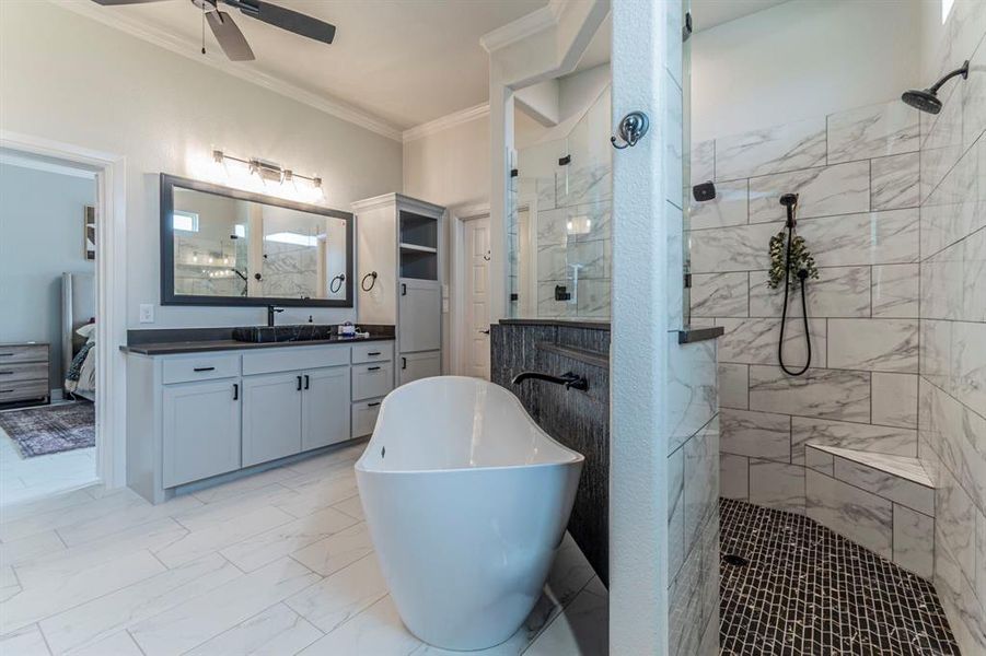 Ensuite bathroom with crown molding, a marble finish shower, vanity, a soaking tub, and a ceiling fan Ensuite bathroom with crown molding, a marble finish shower, vanity, a soaking tub, and a ceiling fan
