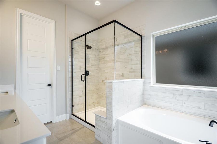 Full bathroom featuring a bath, a stall shower, and vanity Full bathroom featuring a bath, a stall shower, and vanity