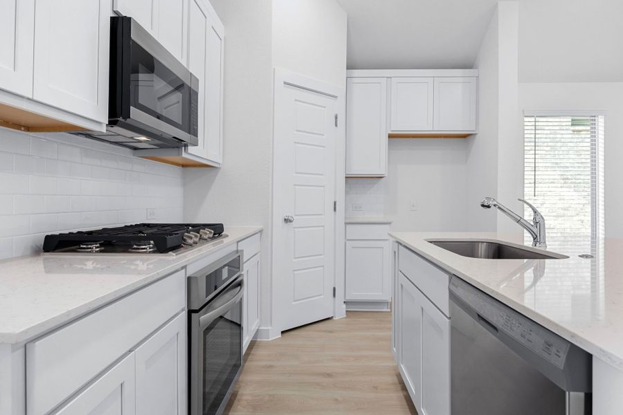 Kitchen in the Cypress home plan by Trophy Signature Homes - REPRESENTATIVE PHOTO