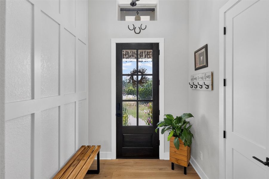 Front entry from inside. Designer wall on left and coat closet on the right. Front entry from inside. Designer wall on left and coat closet on the right.