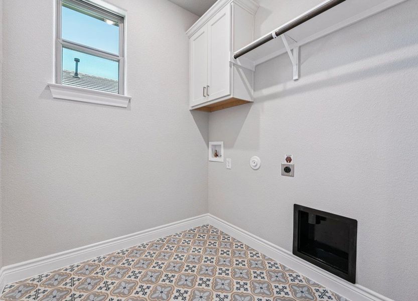 Laundry room with hookup for an electric dryer, gas dryer hookup, cabinet space, and hookup for a washing machine