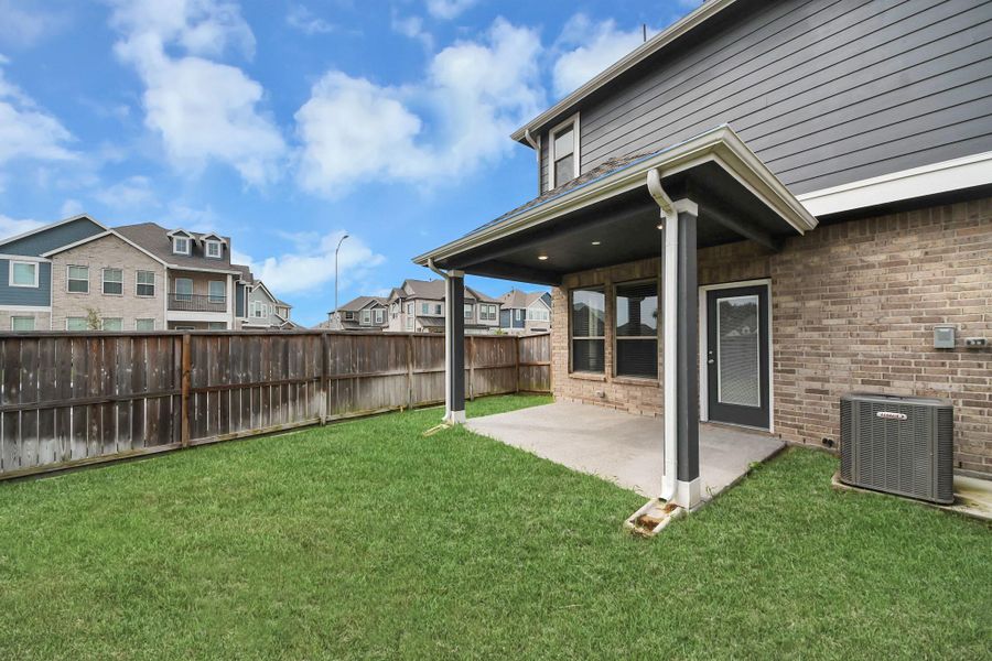 Exterior details and patio area of a home in The Groves, Humble (Image 28).