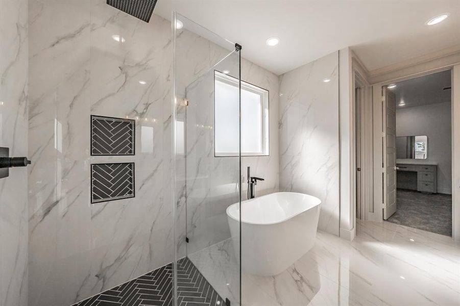 Bathroom featuring a marble finish shower, a freestanding bath, stone wall, marble tiled floors, and recessed lighting