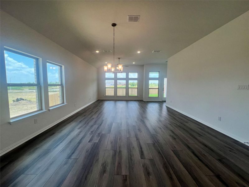 Unfurnished dining area with a chandelier, dark wood-style flooring, and recessed lighting Unfurnished dining area with a chandelier, dark wood-style flooring, and recessed lighting