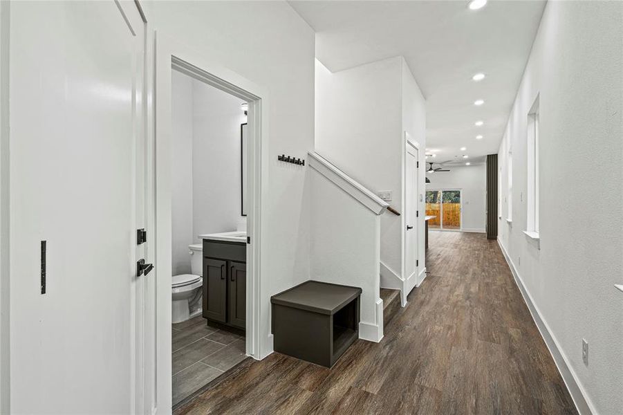 Corridor featuring dark wood-style floors, recessed lighting, and stairs