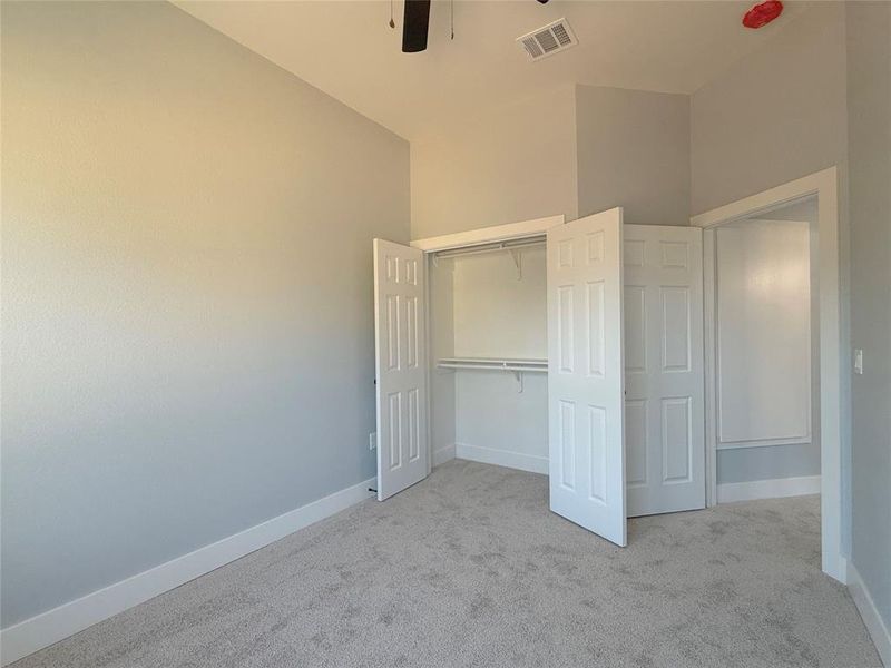 Secondary bedroom with spacious two-door closet.