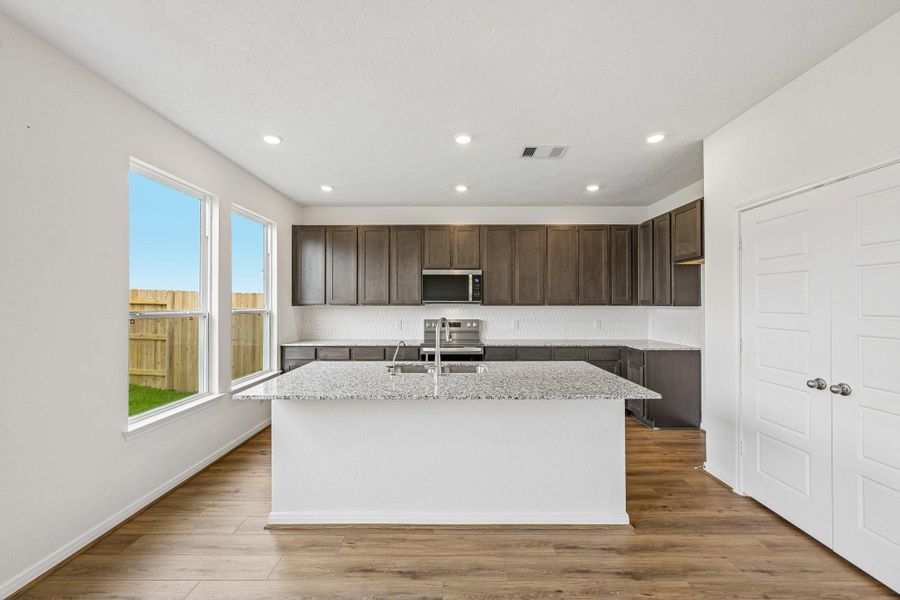 This spacious kitchen has it all—ample storage, generous counter space, and a layout that truly makes it the heart of the home.