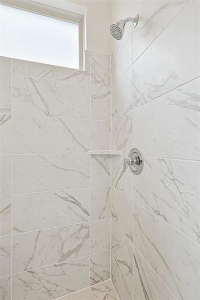 Room details with tiled shower