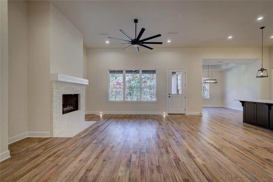 Gorgeous brick fireplace, ceiling fan, and can lights, plus red oak hardwood floors.