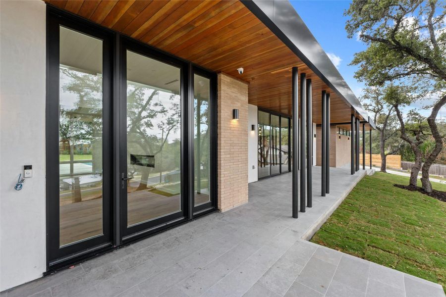 Front porch has commanding neighborhood view. Douglas fir tongue and groove wood on overhand with break metal supports.