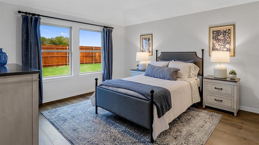 Bedroom featuring wood finished floors Bedroom featuring wood finished floors