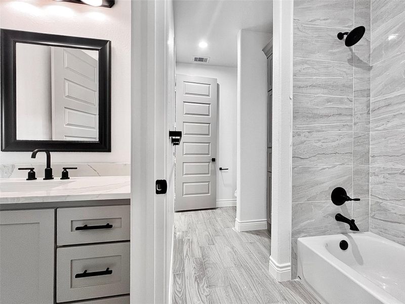 3rd. Bedrooms private sink vanity while sharing Shower/Tub and Commode with 2nd Bedroom.