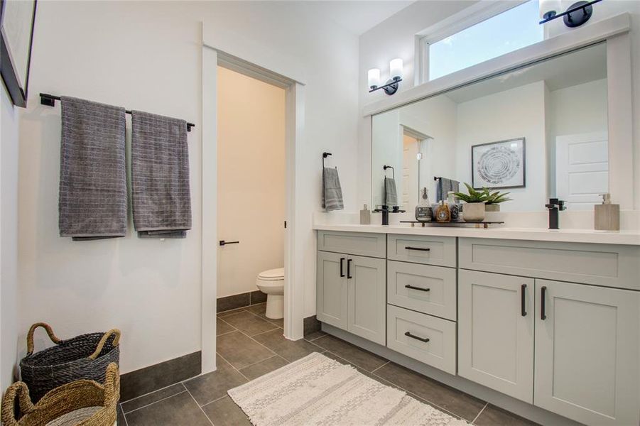 Gorgeous primary bathroom with quartz double sink vanity. Photos from another community by the same builder, FINISHES & FLOOR PLAN WILL VARY!