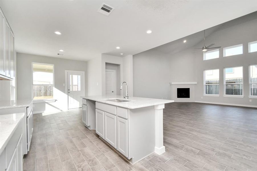 All of this overlooks your expansive family room, creating a perfect space for culinary delights and family gatherings. Sample photo of completed home with similar floor plan. As-built interior colors and selections may vary.