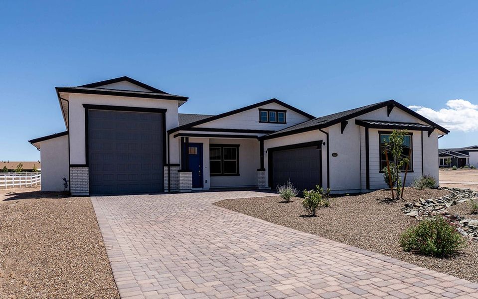 Front exterior of a new home in Heritage Pointe, Chino Valley, AZ, highlighting curb appeal (Image 2). Front exterior of a new home in Heritage Pointe, Chino Valley, AZ, highlighting curb appeal (Image 2).