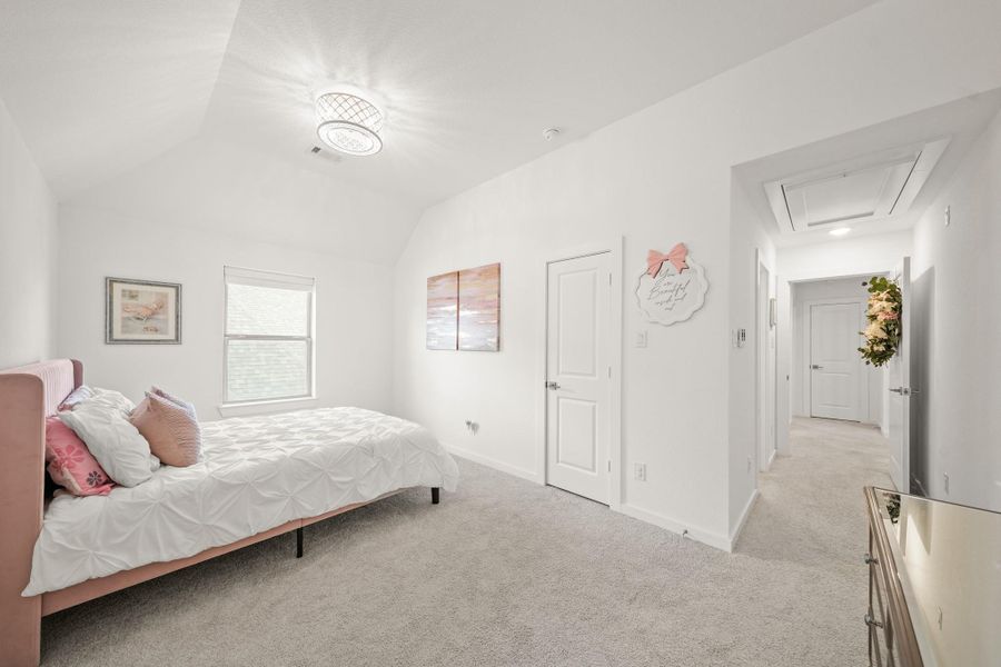 This view highlights the suite’s functional layout with access to the closet and ensuite bath. This room could easily serve as a second primary bedroom.