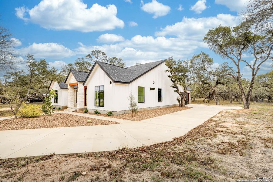 Front exterior of a new home in , Floresville, TX, highlighting curb appeal (Image 27).