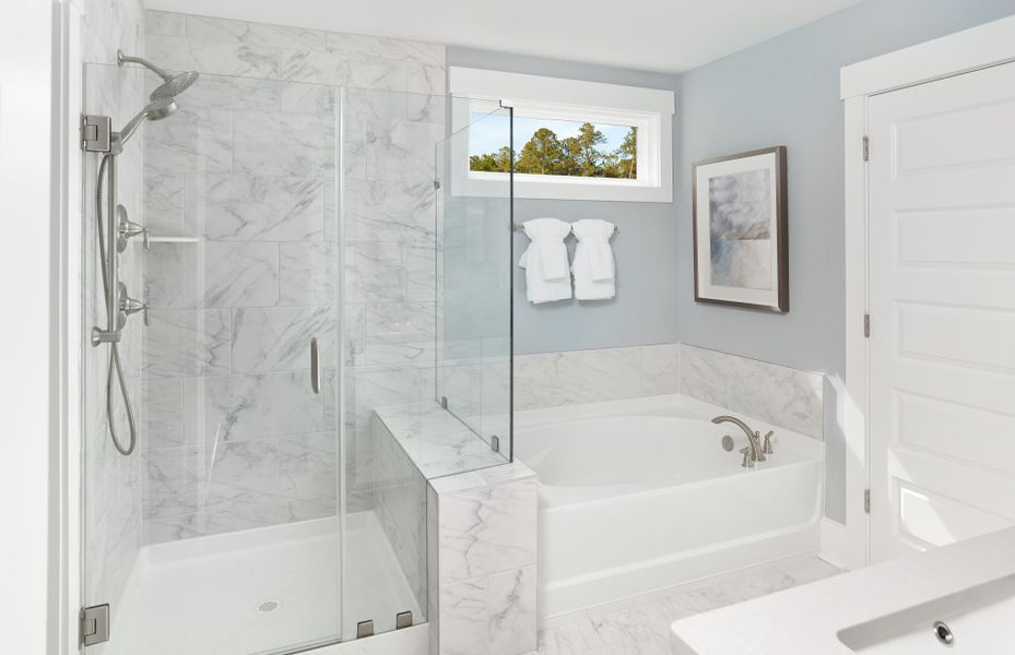 Owner's bath with a frameless walk-in shower and t