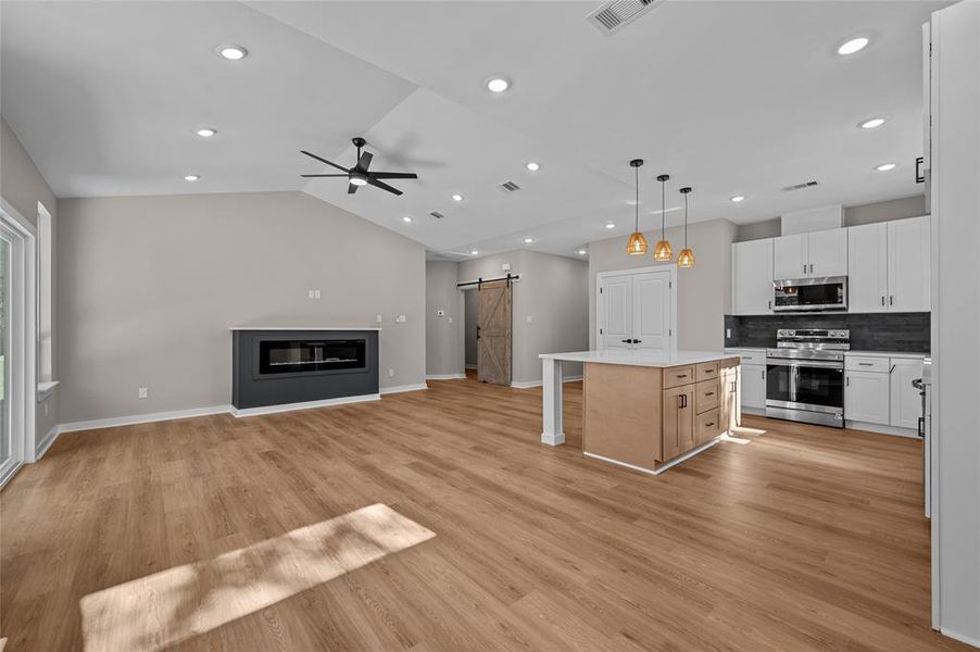 Plenty of space looking from the breakfast room, large electric fireplace and high ceilings.