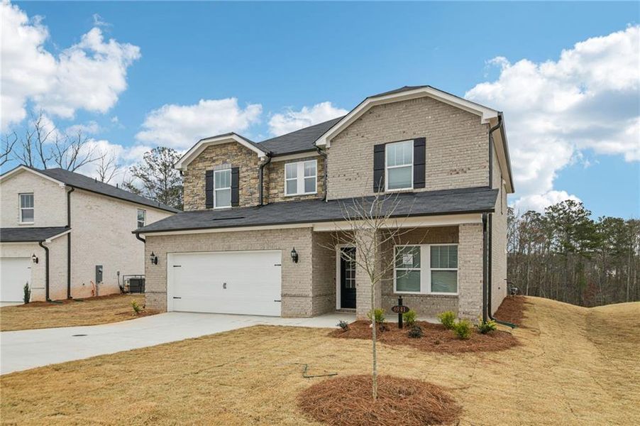 Front exterior of a new home in Creekside at Oxford Park, Fairburn, GA, highlighting curb appeal (Image 2). Front exterior of a new home in Creekside at Oxford Park, Fairburn, GA, highlighting curb appeal (Image 2).