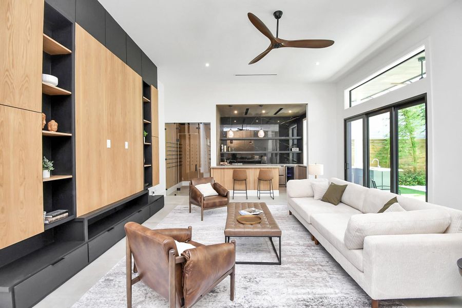 Living room features sliding doors with easy access to the side yard with pool.