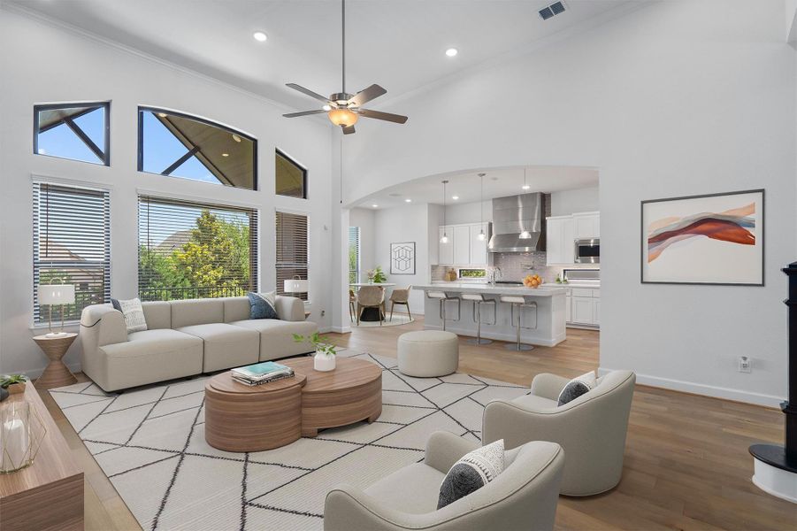 Open-concept living area featuring high vaulted ceilings, expansive window wall with transoms, recessed lighting, and wood-finish flooring