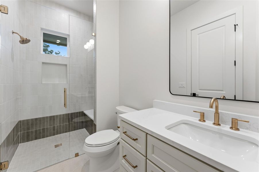 Bathroom featuring vanity and a shower stall
