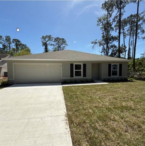 Front exterior of a new home in Palm Coast: Value Collection, Palm Coast, FL, highlighting curb appeal (Image 2).